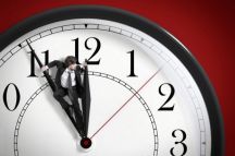 man-pushing-against-clock-hands