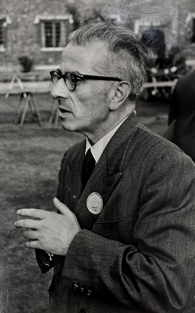 A photograph of Benveniste, wearing a suit and looking to the side